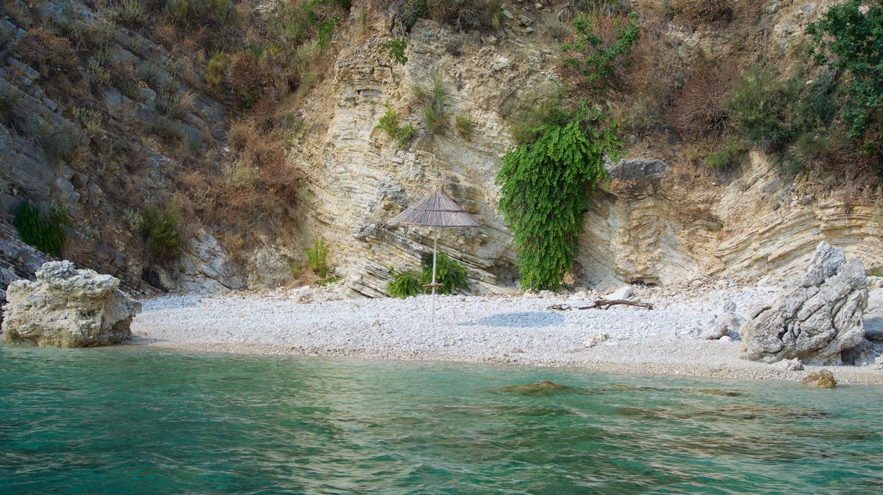 190828 10 Checking out the water in Porto Palermo Albania Private beach with umbrella